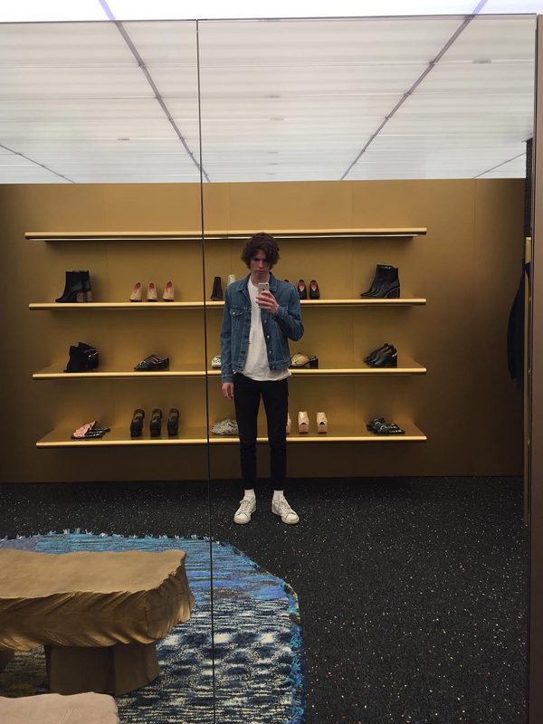 me, trying on a denim jacket at Acne Studios, in New York City